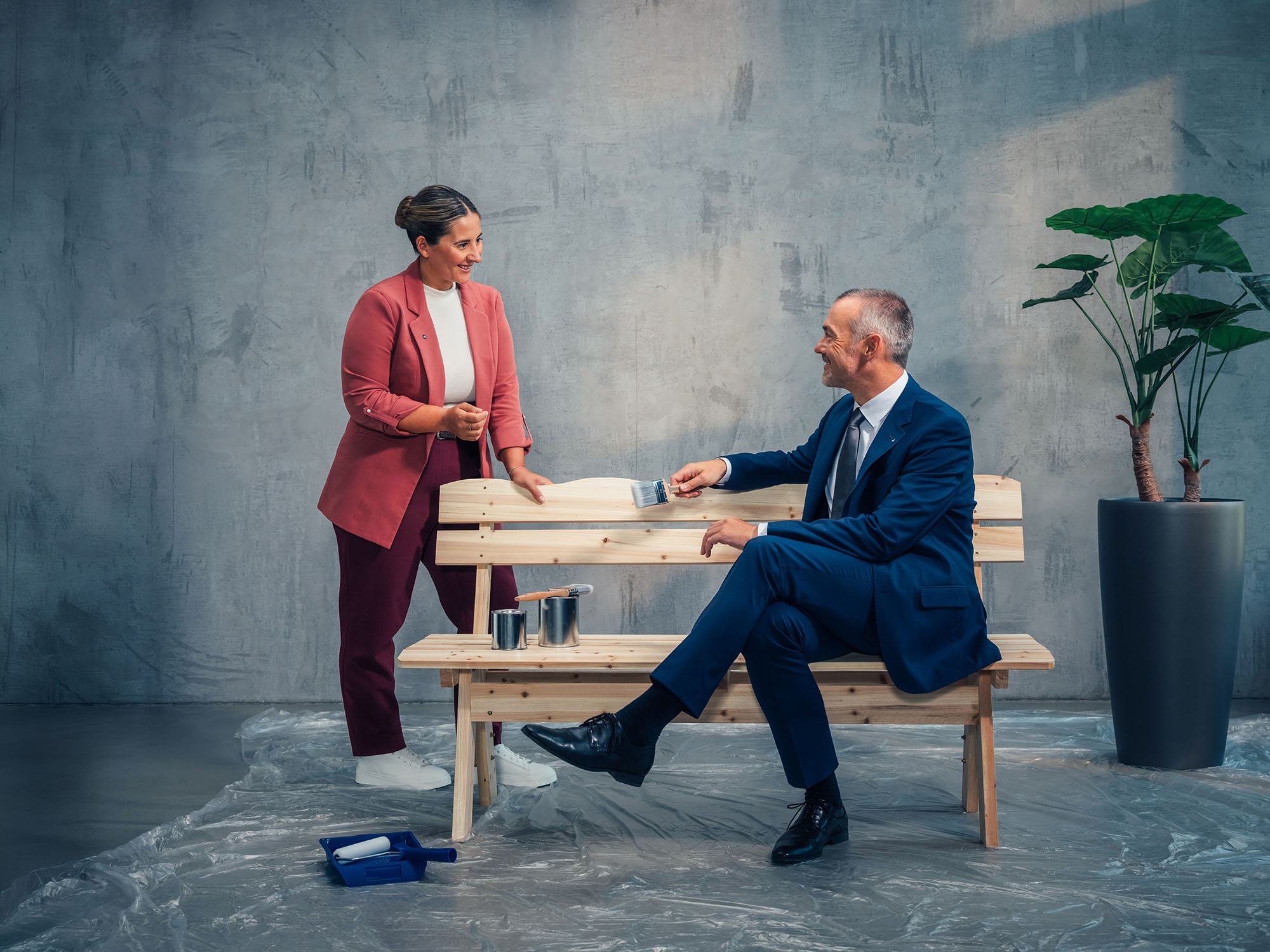 Zwei Personen sitzen an einer Holzbank und besprechen die Gestaltung oder Renovierung einer Holzbank.